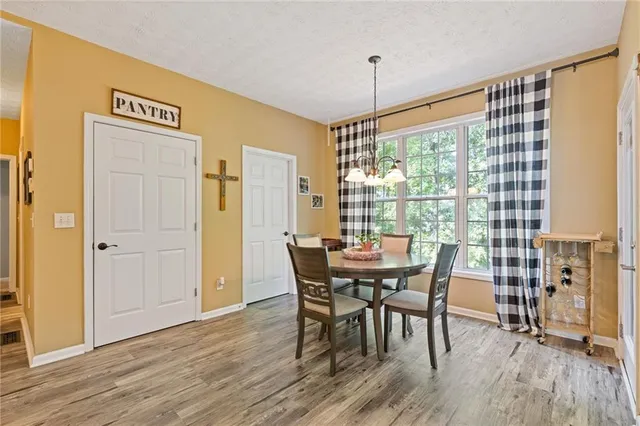 a view of a dining room with furniture window and wooden floor