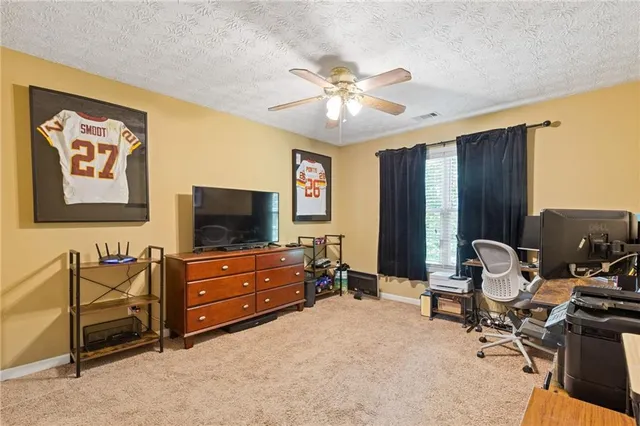 a bedroom with a bed dresser and a window