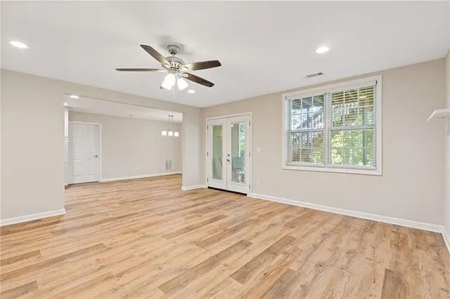 wooden floor in an empty room with a window