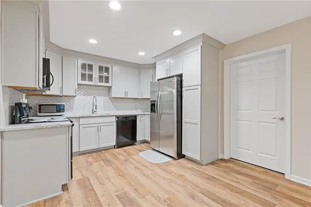 a kitchen with stainless steel appliances granite countertop a stove and a microwave