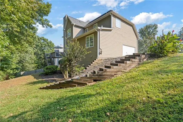an aerial view of residential houses with outdoor space and swimming pool