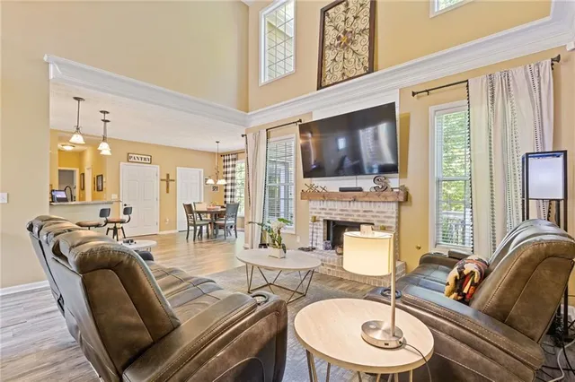 a living room with fireplace furniture and a flat screen tv