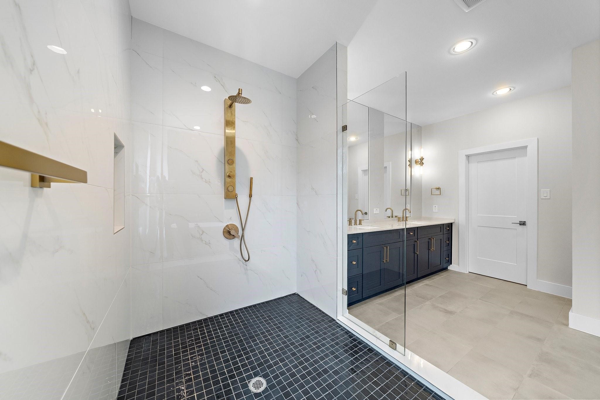 2200 Marnel Road, Unit J Houston, TX 77055 - Photo 13 of 25 a bathroom with a double vanity sink a mirror and a shower
