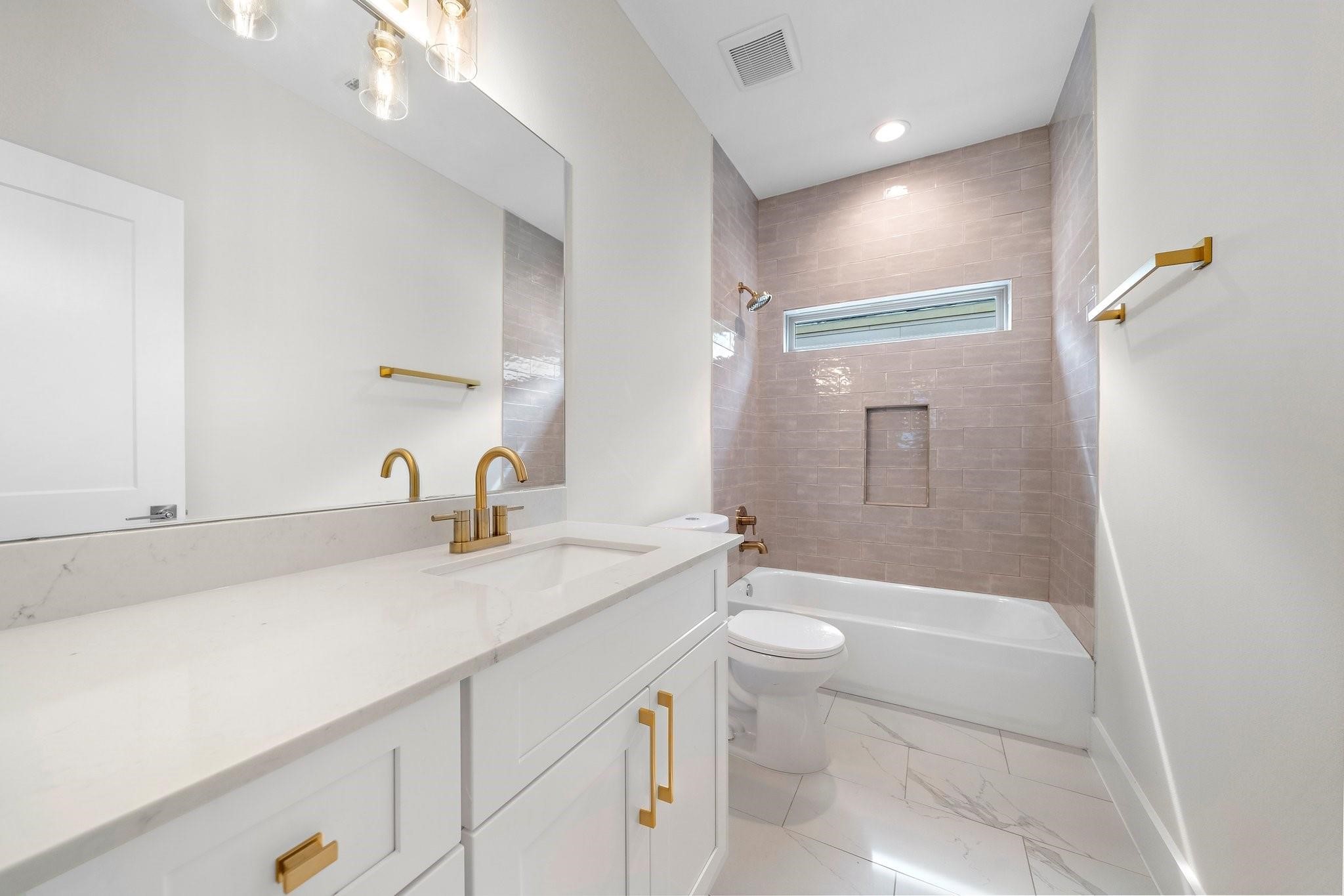 2200 Marnel Road, Unit J Houston, TX 77055 - Photo 19 of 25 a bathroom with a sink a toilet and shower