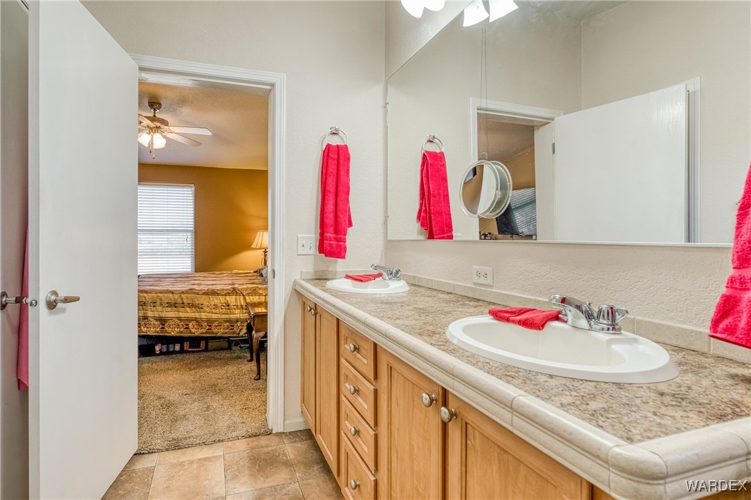 3690 Bouse Road Golden Valley, AZ 86413 - Photo 16 of 47 a bathroom with a sink and a mirror