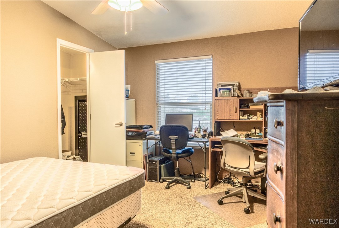 3690 Bouse Road Golden Valley, AZ 86413 - Photo 19 of 47 a view of a workspace with furniture and a window