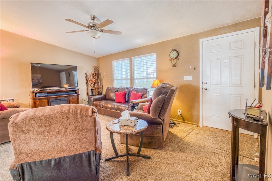 3690 Bouse Road Golden Valley, AZ 86413 - Photo 3 of 47 a living room with furniture a flat screen tv and a window