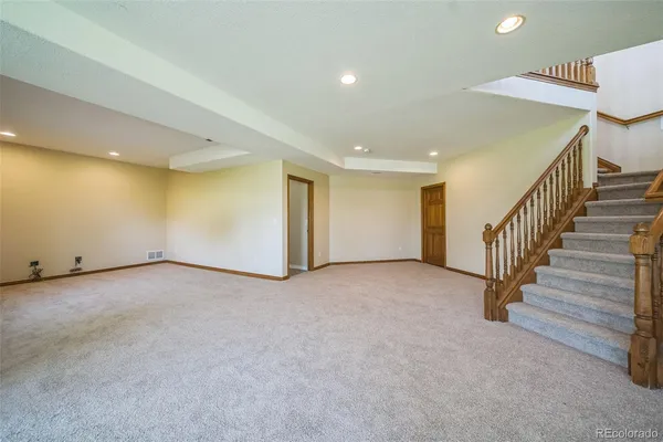 a view of an empty room with stairs