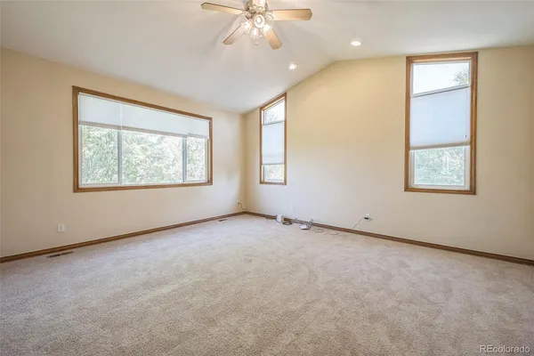 an empty room with windows and closet