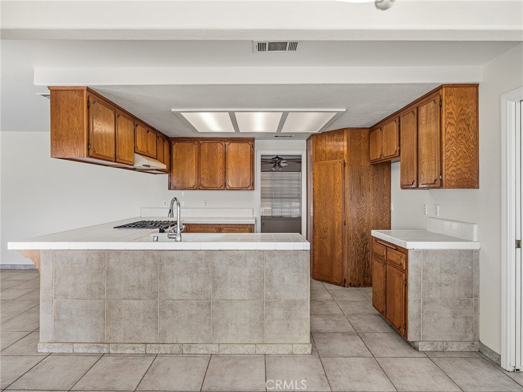 9550 Riggins Road Phelan, CA 92371 - Photo 12 of 47 a kitchen with stainless steel appliances granite countertop a sink and a refrigerator