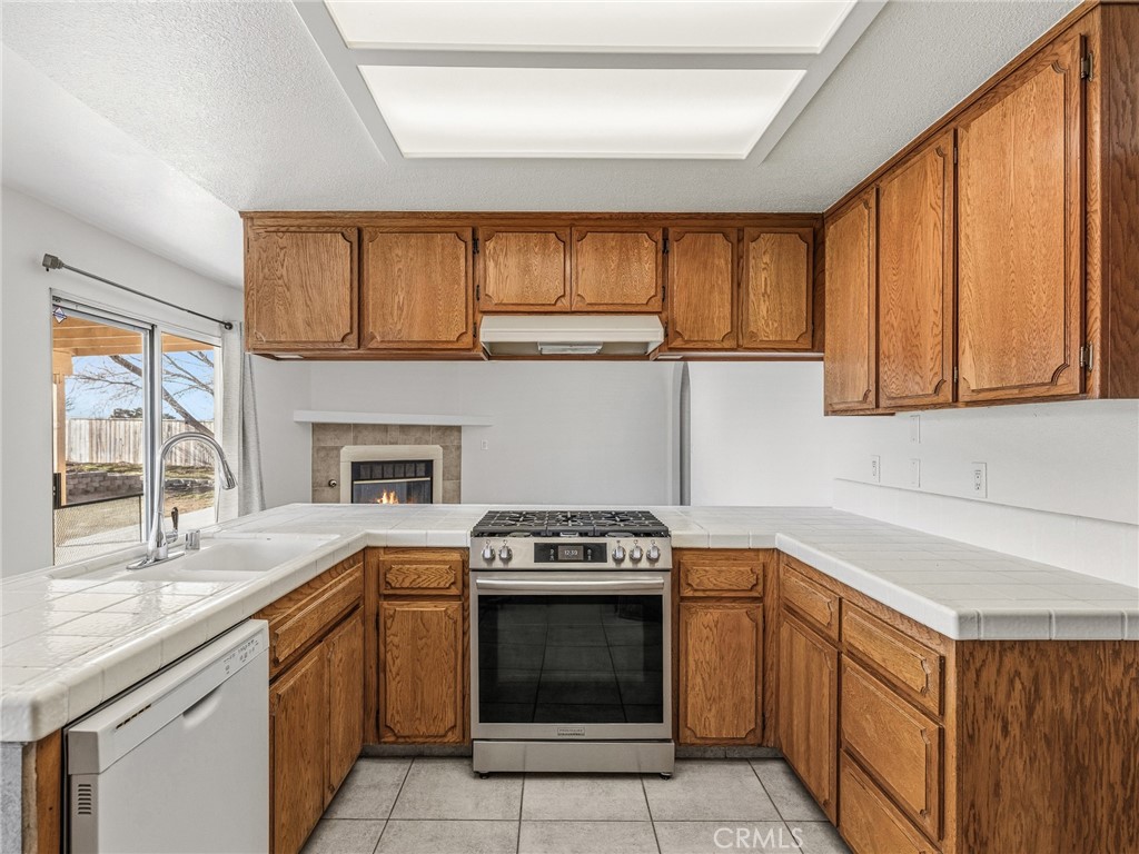 9550 Riggins Road Phelan, CA 92371 - Photo 13 of 47 a kitchen with a sink stove and cabinets