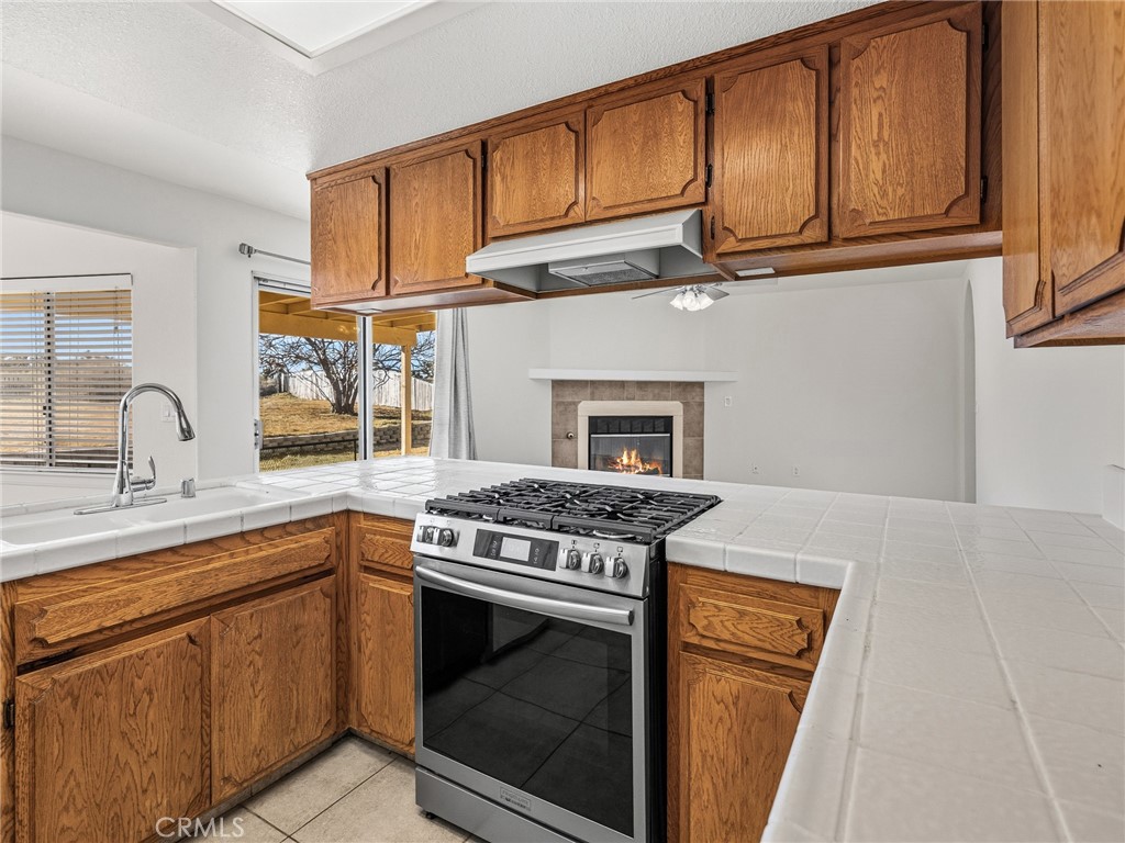 9550 Riggins Road Phelan, CA 92371 - Photo 14 of 47 a kitchen with stainless steel appliances granite countertop a stove and a sink