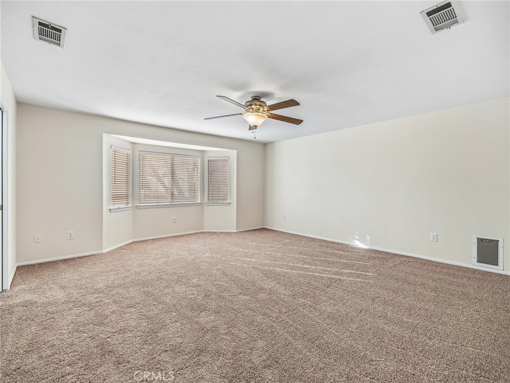 9550 Riggins Road Phelan, CA 92371 - Photo 19 of 47 an empty room with an empty space and a ceiling fan