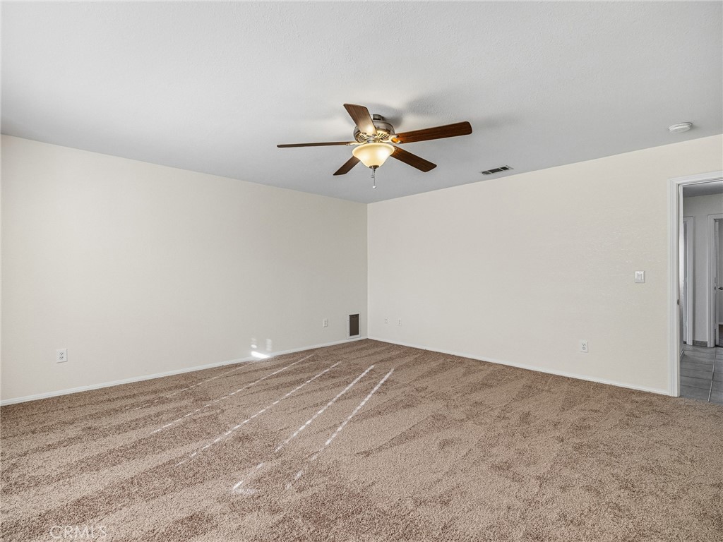 9550 Riggins Road Phelan, CA 92371 - Photo 20 of 47 a view of a big room with carpet