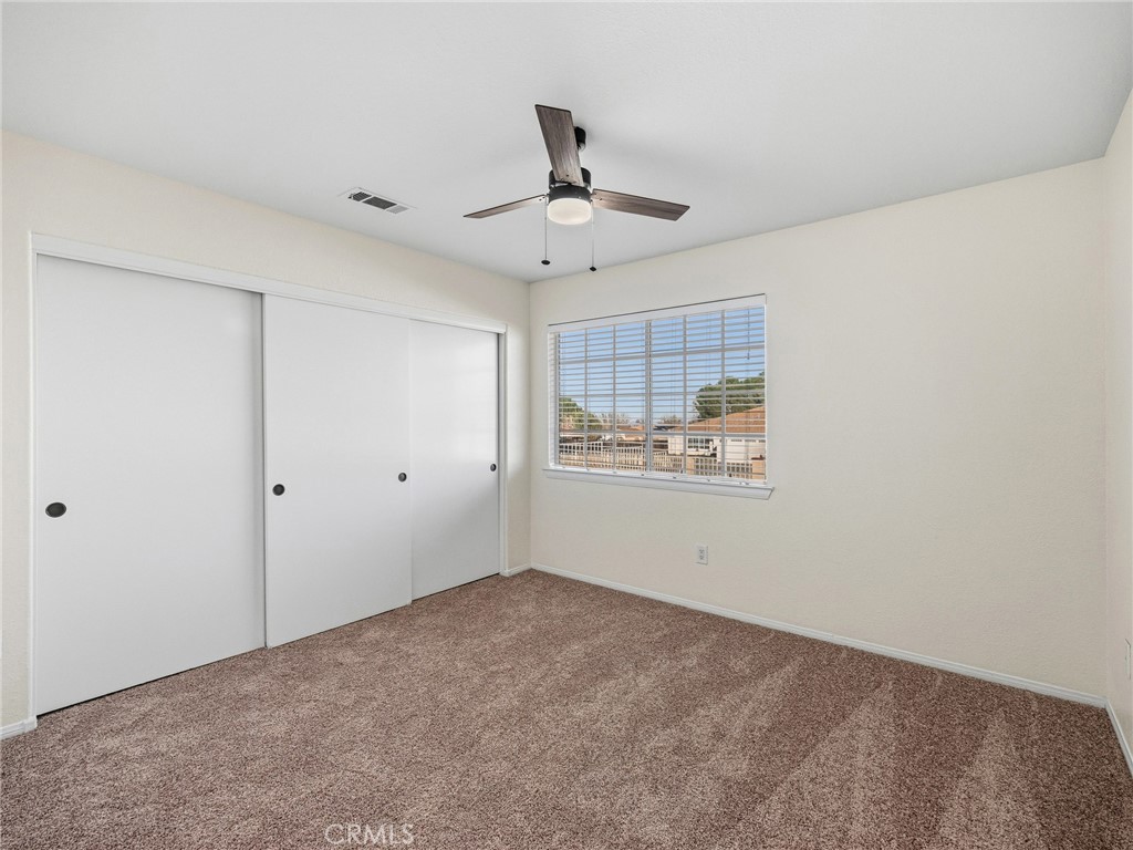 9550 Riggins Road Phelan, CA 92371 - Photo 27 of 47 a view of a room with an empty space and a ceiling fan
