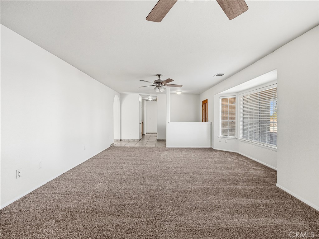 9550 Riggins Road Phelan, CA 92371 - Photo 4 of 47 an empty room with chandelier fan and windows