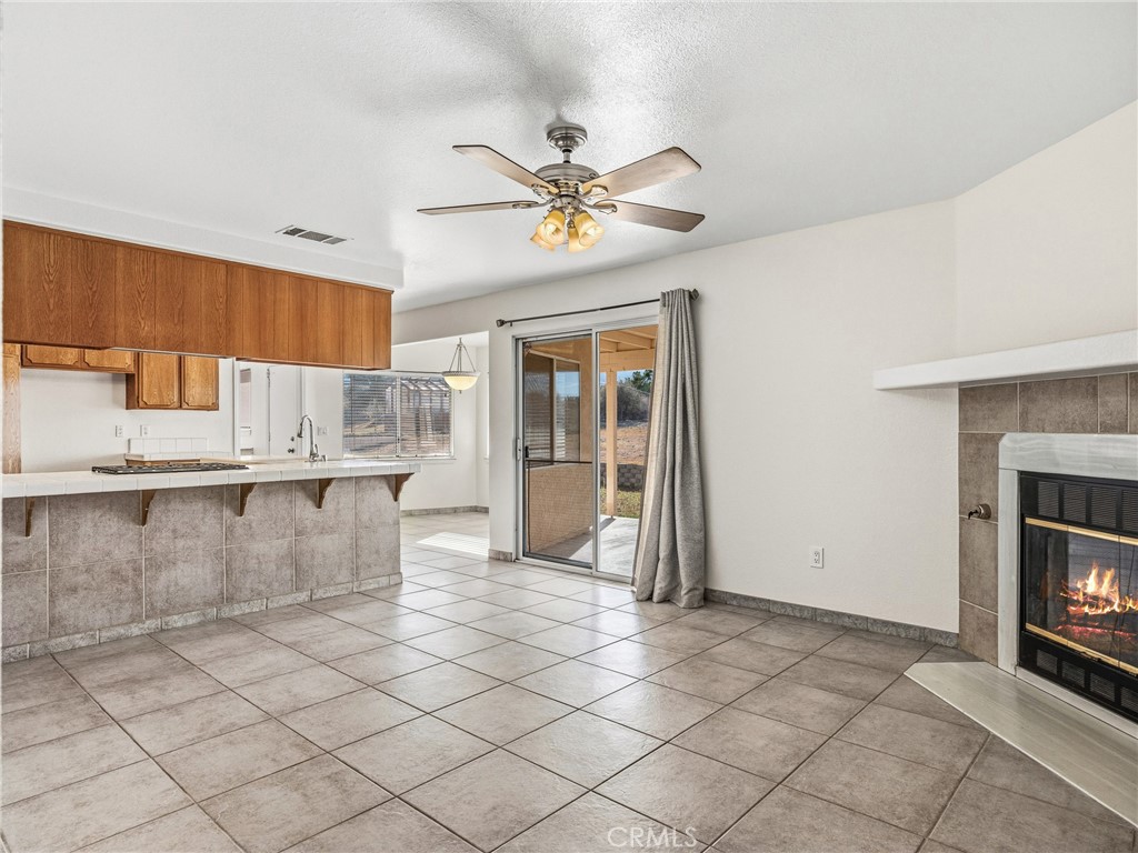 9550 Riggins Road Phelan, CA 92371 - Photo 7 of 47 a view of a kitchen with furniture and a fireplace