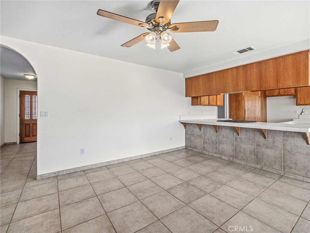 9550 Riggins Road Phelan, CA 92371 - Photo 9 of 47 an empty room with windows and fan
