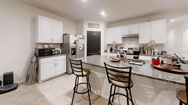 a kitchen with refrigerator and cabinets
