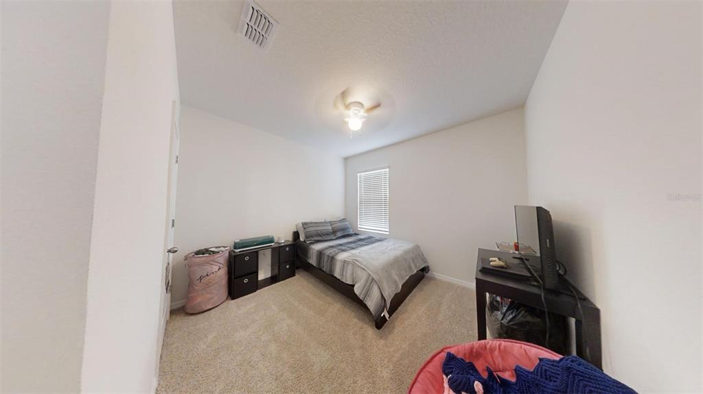 1818 Myrtlebrooke Drive Edgewater, FL 32141 - Photo 17 of 23 a bedroom with a bed and dresser