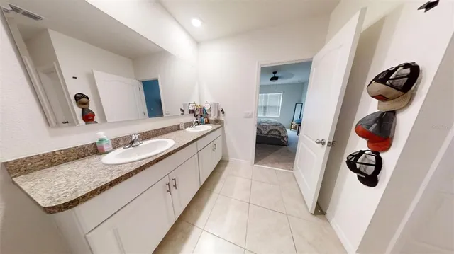 a bedroom with a large bed and a flat tv screen on a dresser