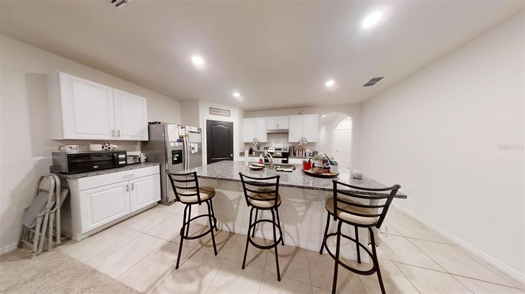 1818 Myrtlebrooke Drive Edgewater, FL 32141 - Photo 22 of 23 a kitchen with a sink and white cabinets