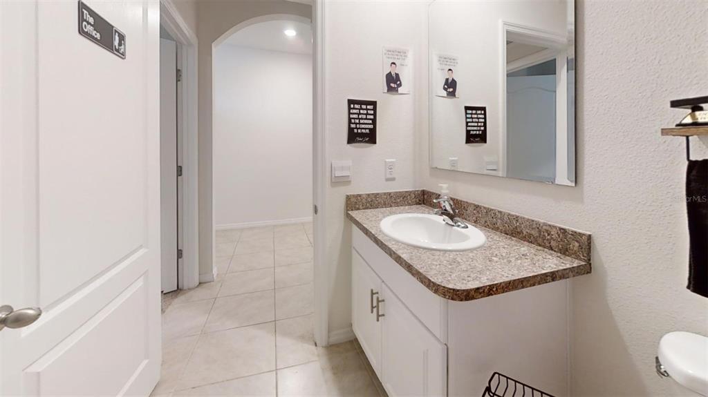 1818 Myrtlebrooke Drive Edgewater, FL 32141 - Photo 5 of 23 workspace with granite countertop a sink and a mirror