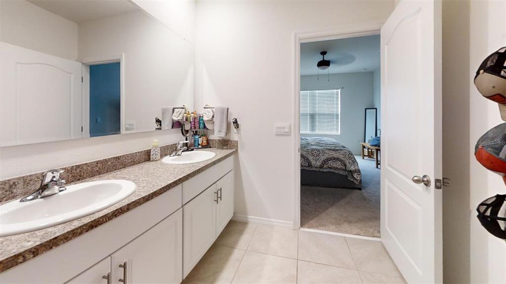 1818 Myrtlebrooke Drive Edgewater, FL 32141 - Photo 6 of 23 a en suite bathroom with a granite countertop sink and a mirror