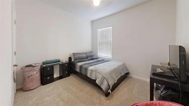 a bedroom with a bed and a desk