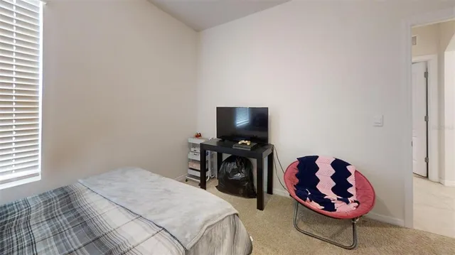 a bedroom with a bed and a chair
