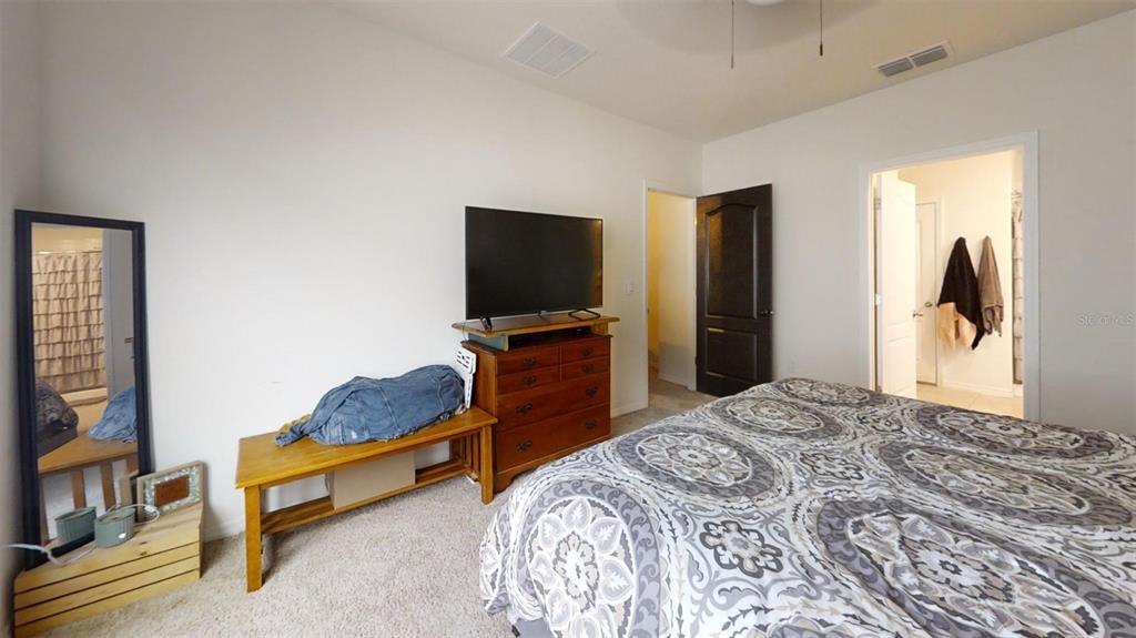 1818 Myrtlebrooke Drive Edgewater, FL 32141 - Photo 10 of 23 a bedroom with bed and tv