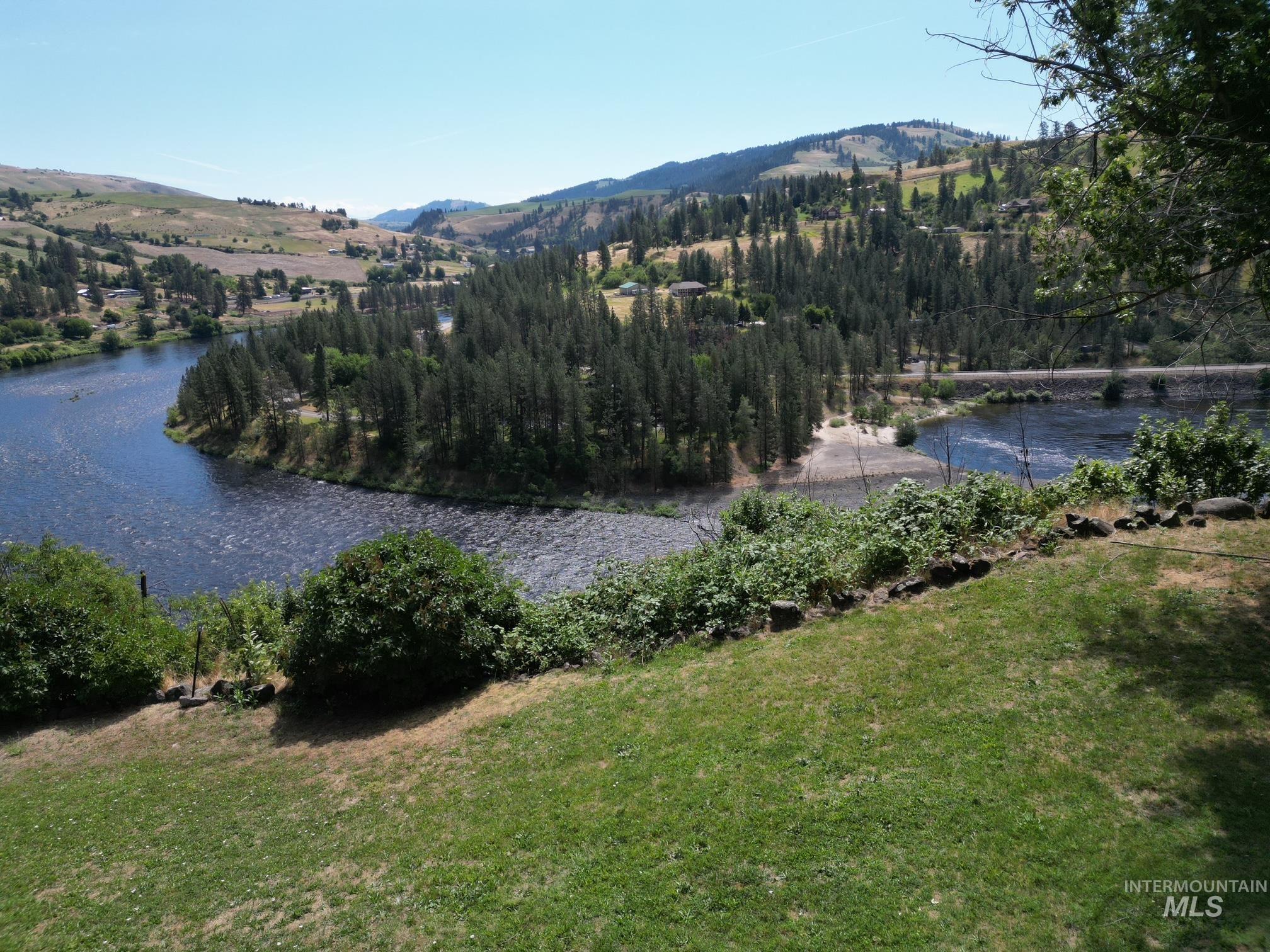 35322 River Road Lenore, ID 83541 - Photo 42 of 42 Expansive riverfront property featuring a meandering river, dense evergreen forests, and distant rolling hills