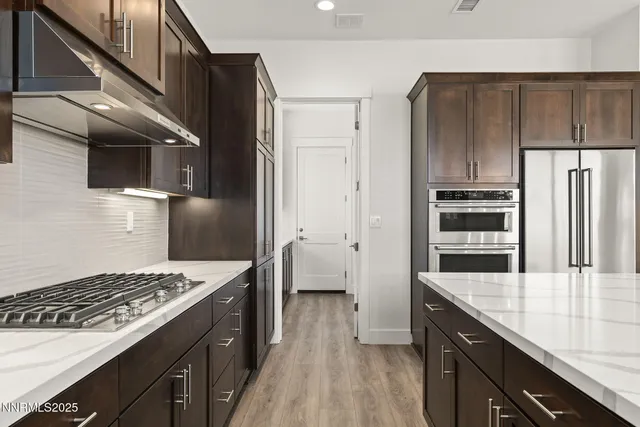a kitchen with wooden cabinets and a stove top oven