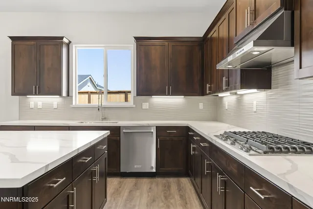 a kitchen with a sink stove top oven and cabinets
