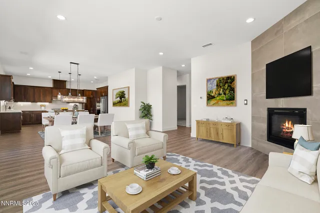 a living room with furniture a flat screen tv and a fireplace