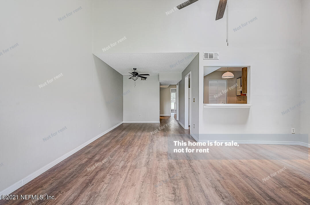 10740 Alden Road, Unit 4 Jacksonville, FL 32246 - Photo 13 of 28 a view of an empty room with wooden floor and a window