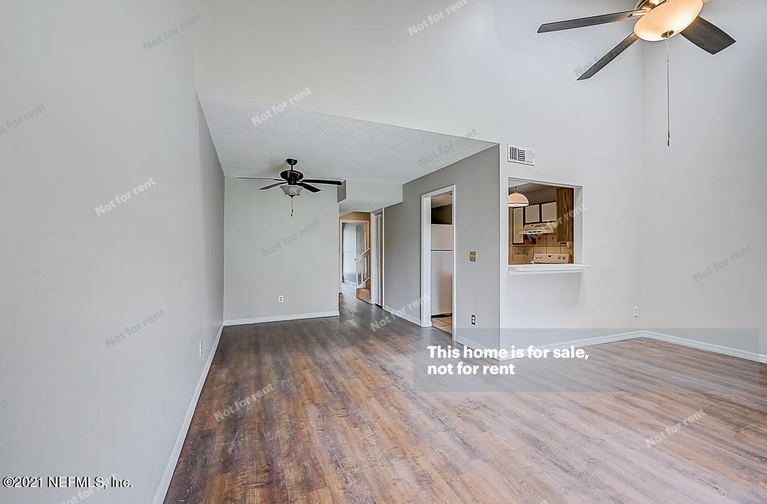 10740 Alden Road, Unit 4 Jacksonville, FL 32246 - Photo 14 of 28 a view of a hallway with wooden floor and a ceiling fan