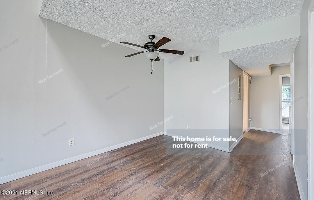 10740 Alden Road, Unit 4 Jacksonville, FL 32246 - Photo 15 of 28 a view of a big room with wooden floor a ceiling fan and closet