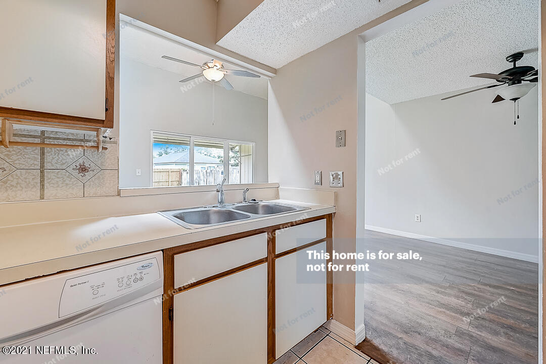 10740 Alden Road, Unit 4 Jacksonville, FL 32246 - Photo 17 of 28 a kitchen with a sink cabinets and wooden floor