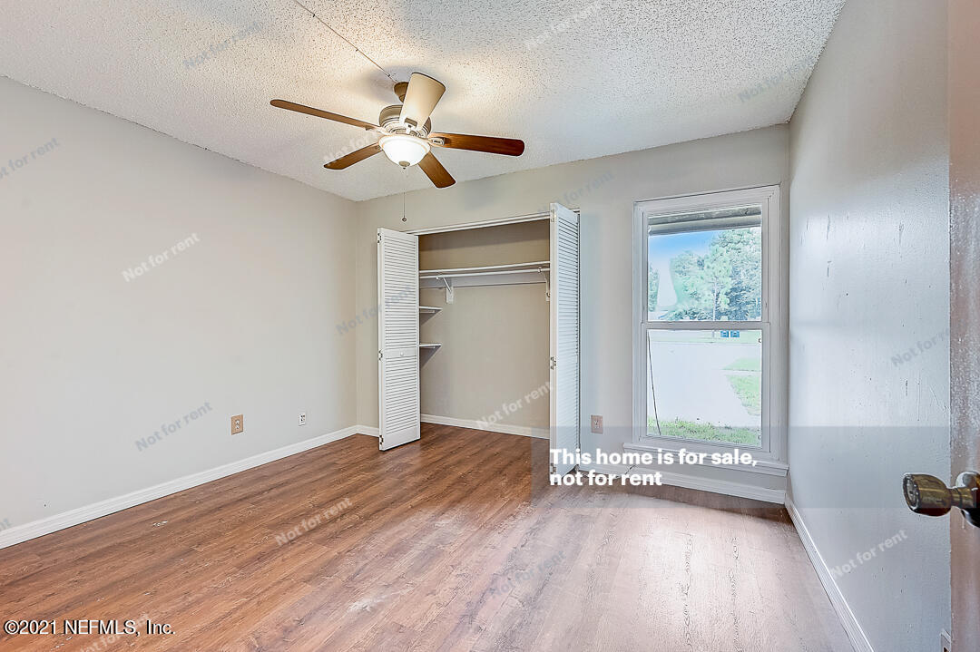 10740 Alden Road, Unit 4 Jacksonville, FL 32246 - Photo 19 of 28 an empty room with wooden floor fan and windows