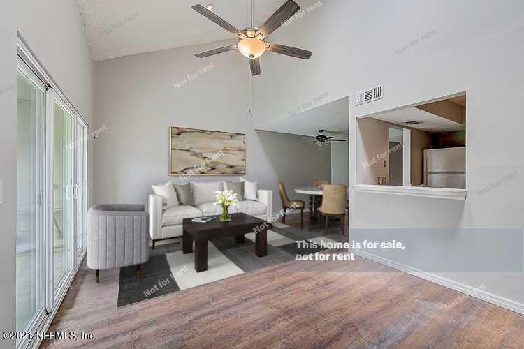 10740 Alden Road, Unit 4 Jacksonville, FL 32246 - Photo 2 of 28 a living room with furniture and a chandelier