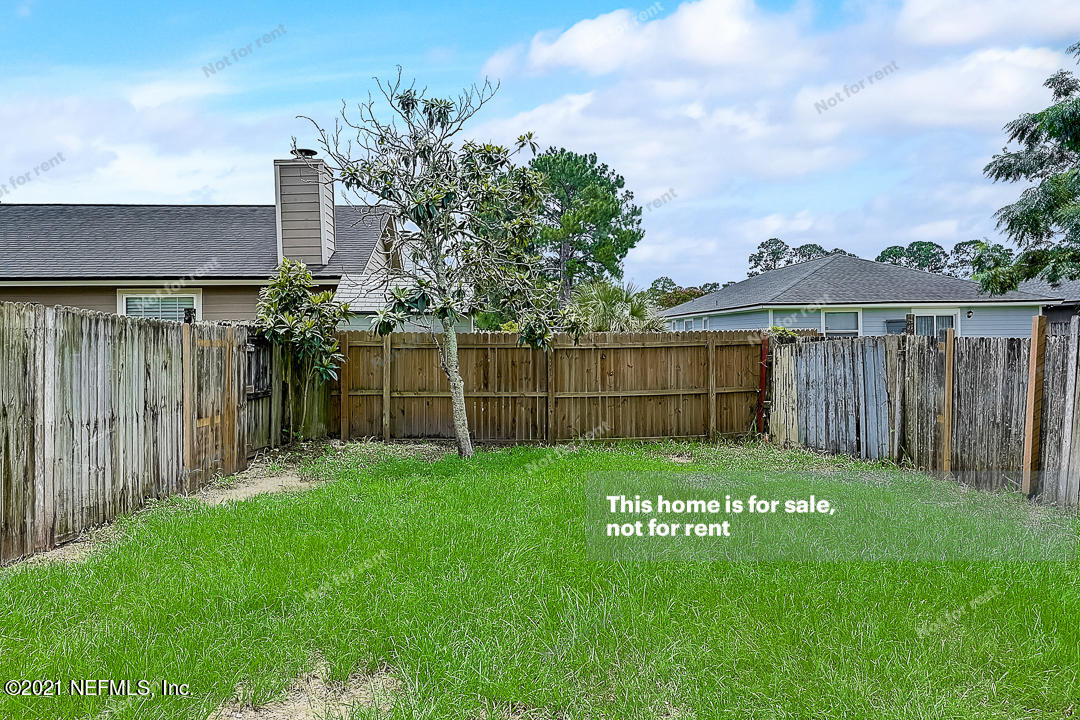 10740 Alden Road, Unit 4 Jacksonville, FL 32246 - Photo 25 of 28 a view of a deck with a big yard and a large trees