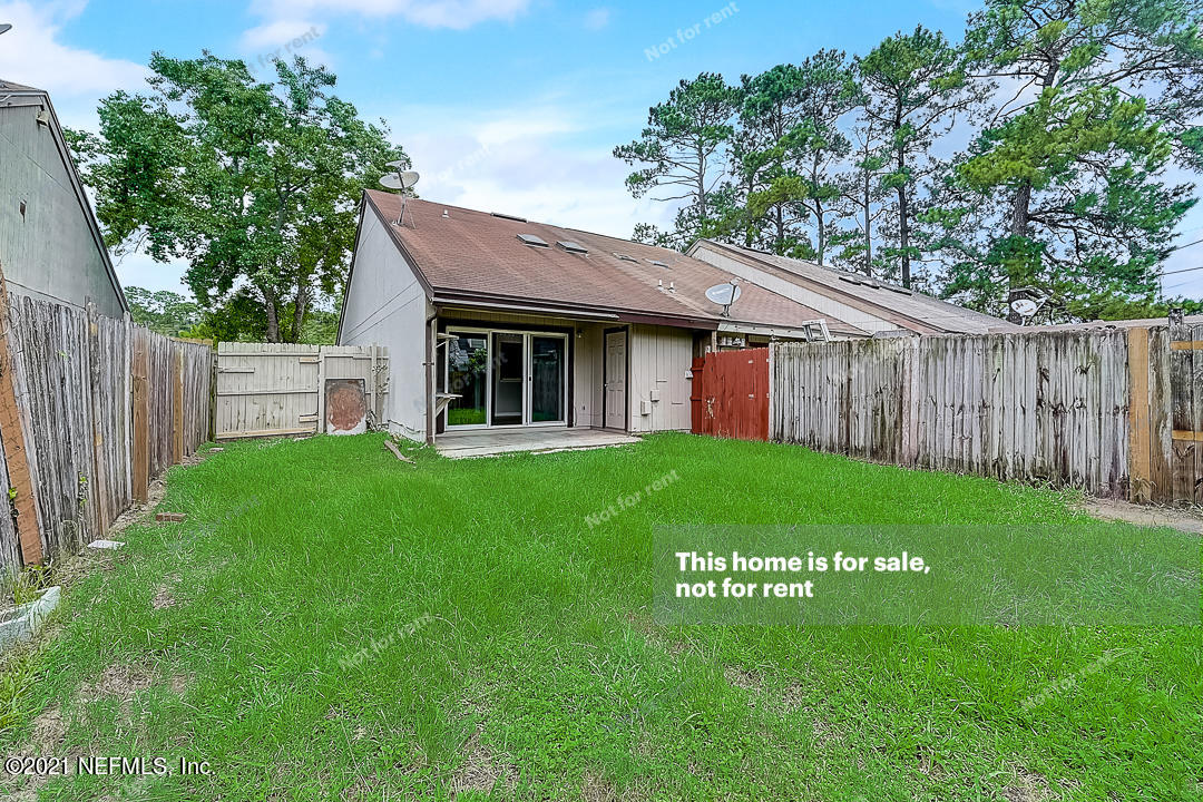10740 Alden Road, Unit 4 Jacksonville, FL 32246 - Photo 28 of 28 a view of a house with a yard plants and large tree