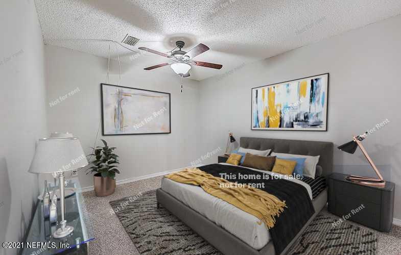 10740 Alden Road, Unit 4 Jacksonville, FL 32246 - Photo 3 of 28 a bedroom with bed and wooden floor