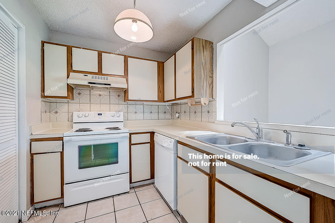 10740 Alden Road, Unit 4 Jacksonville, FL 32246 - Photo 4 of 28 a kitchen with stainless steel appliances granite countertop a sink stove and cabinets