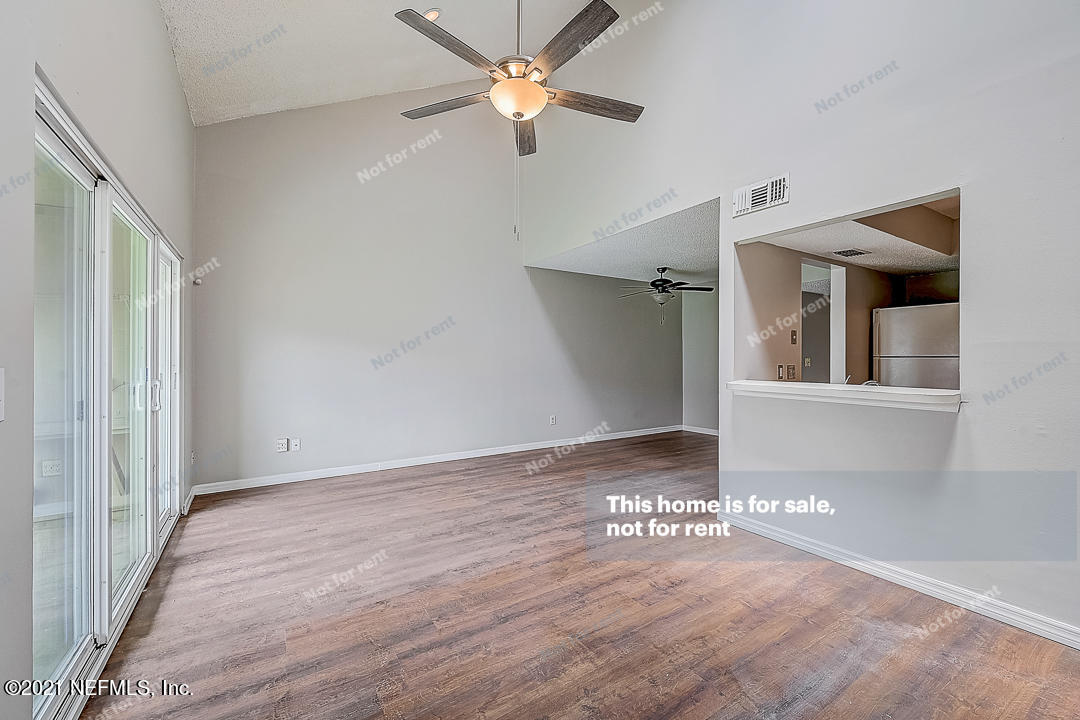 10740 Alden Road, Unit 4 Jacksonville, FL 32246 - Photo 6 of 28 a view of an empty room with window and wooden floor