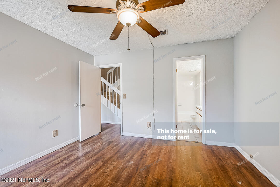 10740 Alden Road, Unit 4 Jacksonville, FL 32246 - Photo 8 of 28 a view of empty room with wooden floor and fan