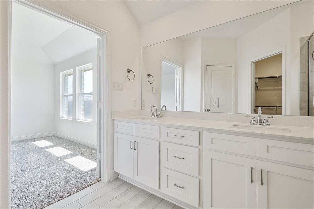 321 Portina Drive Anna, TX 75409 - Photo 25 of 35 a bathroom with double sink and a mirror