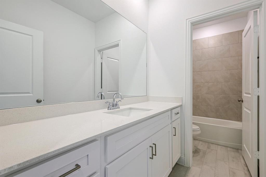 321 Portina Drive Anna, TX 75409 - Photo 27 of 35 a bathroom with a sink and a mirror