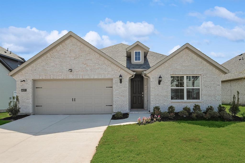 321 Portina Drive Anna, TX 75409 - Photo 3 of 35 a front view of a house with a yard and garage